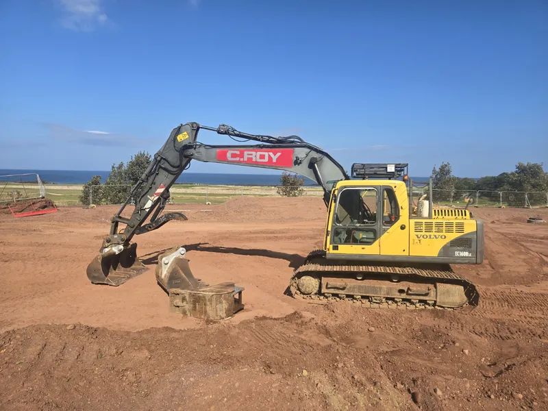 C.ROY excavator working on the coast with the sea behind